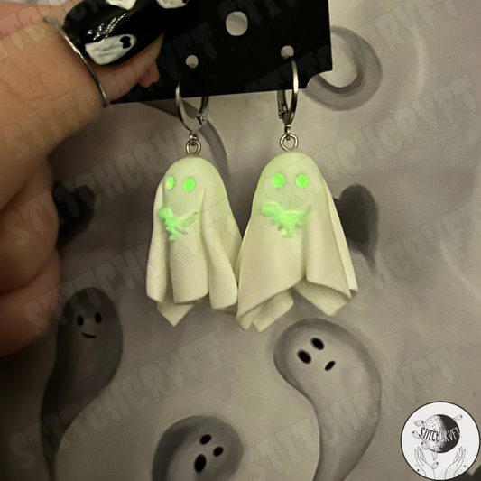 Sheet ghost earrings holding tiny glowing trex with glowing eyes | Handmade to order