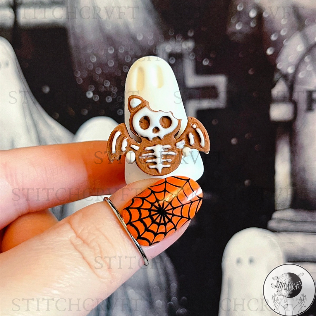 Ghost holding tiny gingerbread skelebat | Handmade to order